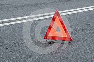 Red warning triangle on the carriageway with a double dividing strip