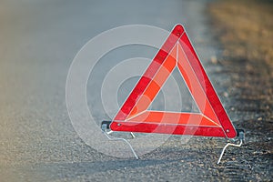 Red warning triangle on a road suggesting a broken down car