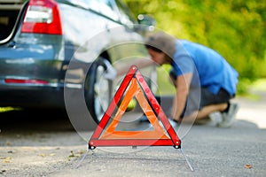 Red warning triangle sign on the road