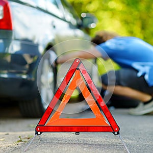 Red warning triangle sign on the road