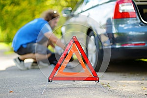 Red warning triangle sign on the road