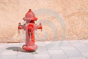 Red water fire hydrant on pavement of city street. Firefighting and design concept