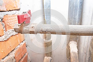 Red water valve on old metal pipe line