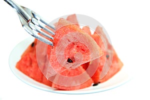 Red watermelon impaled on a fork