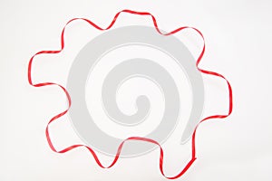 Red wavy ribbon in multiangle shape on white