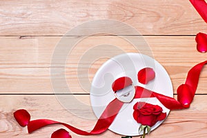 Red wedding decoration with rings and roses.