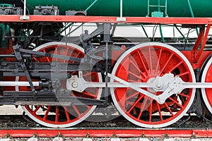 Red wheel and detail of mechanism a vintage russian steam train locomotive