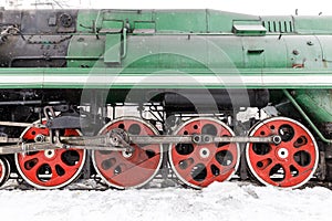 Red wheel and detail of mechanism a vintage russian steam train locomotive