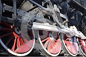 Red wheels of old USSR black steam locomotive. Wheels of an old soviet steam trai