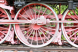 Red wheels and pistons on an old locomotive