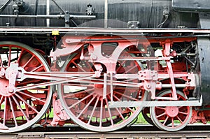 Red wheels and pistons on an old locomotive
