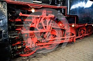 Red wheels of steam train.