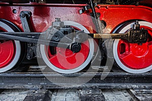 Red wheels of steam train, detail of old locomotive