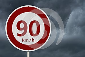 Red and white 90 km speed limit sign