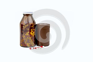 Red, white antibiotic capsules pills and two amber bottles isolated on white background with copy space and blank label.