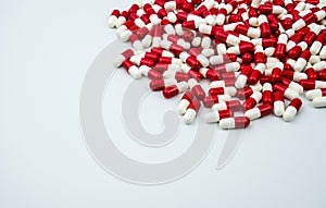 Red, white antibiotic capsules pills on white background with copy space.