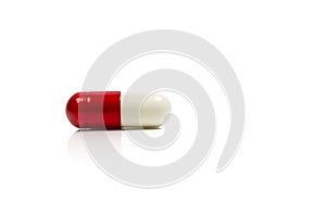 Red, white antibiotics capsule pill isolated on white background photo