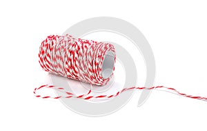 Red and white baker twine spool isolated on white background