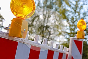 Red and white barricades with warning light