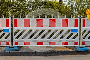 Red and white barricades with warning light