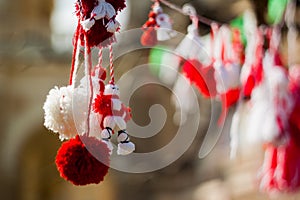Red and white beautiful martisor balls closeup hanging on the branches of the tree