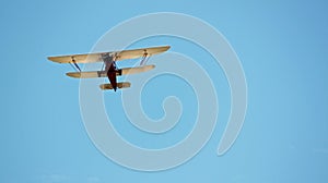 Red and White Biplane Flying in a Blue Sky