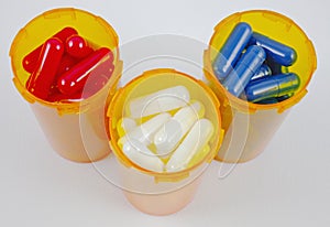 Red, white, and blue capsules in pill bottles