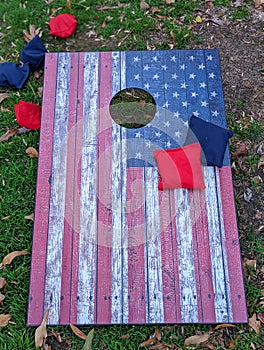Red white and blue cornhole game with stars to look like an American Flag with bean bags