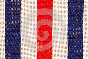 Red, white and blue grunge burlap textured weave material background