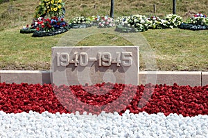 Red, white and blue pinecoins at the rememberance area in The Hague