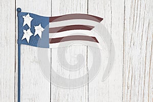 Red, white and blue retro American flag on weathered whitewash textured wood background