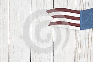 Red, white and blue retro American flag on weathered whitewash textured wood background