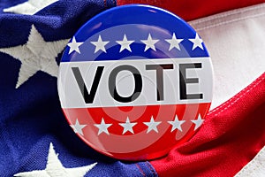 A red, white and blue VOTE button on a blue background