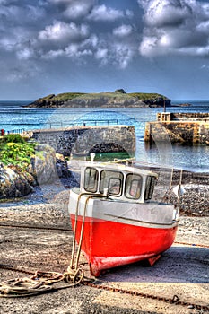 Red and white boat Mullion Cove harbour Cornwall UK in colourful bright HDR