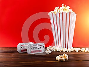 Red and White Bucket Of Popcorn With Two Red Movie Ticket