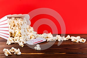 Red and White Bucket Of Popcorn With Two Red Movie Tickets