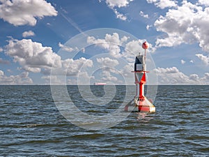 Red-white buoy Otzumer Balje in German Bight north of East Frisian island Langeoog, Germany