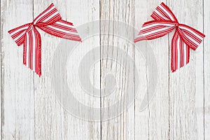 Red and white candy cane bow Christmas background with weathered wood