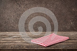 Red-white checkered napkin on wooden table