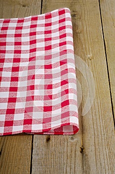 Red-white checkered tablecloth in an old table