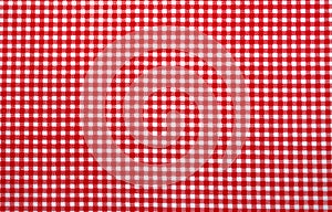 Red and white checkered tablecloth. Top view table cloth texture background. Red gingham pattern fabric. Picnic blanket texture.