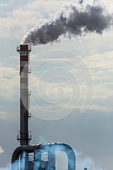 Red and White Chimney Smoking on Cloudy Sky Background