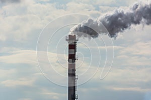 Red and White Chimney Smoking on Cloudy Sky Background