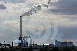 Red and White Chimney Smoking on Cloudy Sky Background