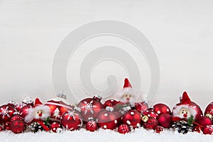 Red and white christmas background of wood with balls and goblin