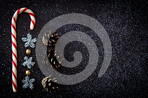 Red and white Christmas candy pine and sparkling snowflakes on a black dark background