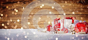 Red and white christmas gifts and baubles on snow 3D rendering