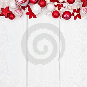 Red and white Christmas ornament top border over white wood