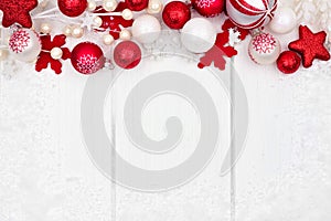 Red and white Christmas ornament top border over white wood