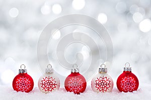 Red and white Christmas ornaments with twinkling silver background photo